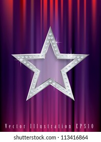 silver star with diamonds on red curtain