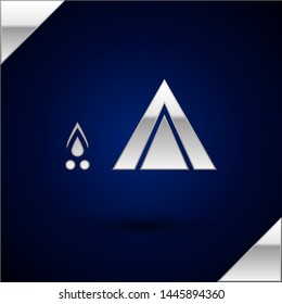 Silver Tourist tent with wood fire icon isolated on dark blue background. Camping symbol.  Vector Illustration