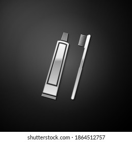 Silver Tube of toothpaste and toothbrush icon isolated on black background. Long shadow style. Vector.