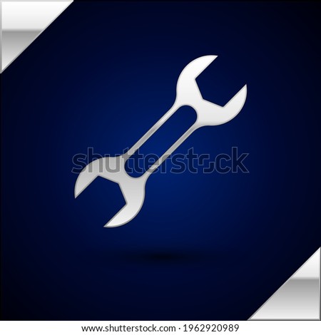 Silver Wrench spanner icon isolated on dark blue background.  Vector