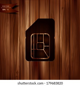 Sim card web icon. Wooden background