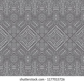 Simmetric seamless pattern in ethnic style. Tribal geometric ornament, perfect for textile design, site background, wrapping paper and other endless fill. Trendy boho tile.