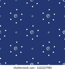 Simple abstract hand drawn white dotted flowers on a navy blue background. This cute seamless vector pattern is perfect for textiles, fashion, gift wrapping paper, wallpaper, scrapbooking and paper.