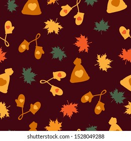 Simple autumn pattern. Dark background, cute hats and mittens, colored maple leaves. The print is suitable for textiles, banner and Wallpaper.