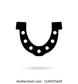 Simple black horseshoe vector icon isolated on white background. Horse shoe silhouette as international good luck symbol. Fortune and success sign