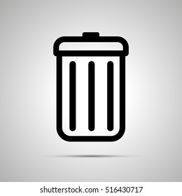 Simple black icon of trash can with shadow on light background