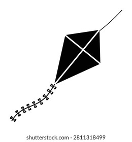A simple black kite soaring through the air with a long tail attached recreational fun