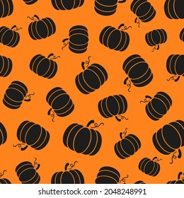 Simple black pumpkin seamless repeat pattern. Irregular, vector cultivar of winter squash plants randomly placed all over print on orange background.