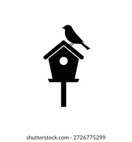 Una silueta negra simple de un pájaro posado en una casa de pájaros