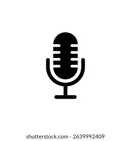 A simple black silhouette depicts a vintage-style microphone on a white background. The microphone features horizontal lines on the upper portion and is supported by a stand.