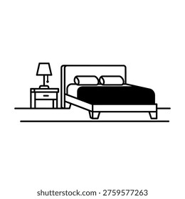 Simple black and white bedroom setup with a cozy bed and bedside table lamp