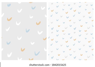 Simple Brush Daubs Isolated on a Light Gray and Off-White Background. Funny Infantile Hand Drawn Doodle Print with Gray, Blue and Gold Irregular Spots.