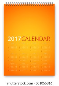Simple calendar 2017 orange colored template. Week starts from sunday. Vector realistic spiral notepad notebook