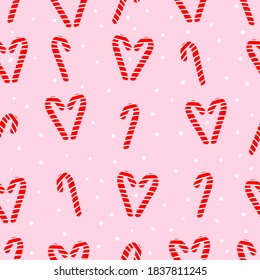 Simple Christmas pattern. Cute candy canes. Soft pink background. Vector texture. Holiday print for packaging.