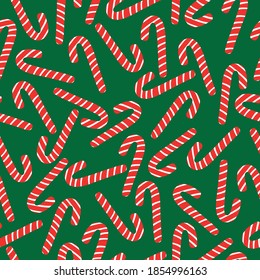 Einfaches Weihnachtsmuster. Große Karamelllbonbons. Grüner Hintergrund. Vektorstruktur. Heller Urlaubstext für Tapeten und Textilien, Verpackung.