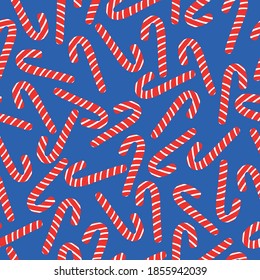 Simple Christmas pattern. Large caramel canes. Blue background. Vector texture. Holiday print for Wallpaper and textiles.