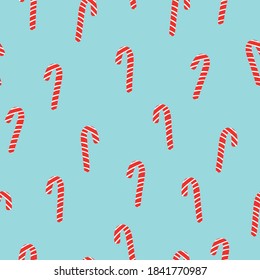 Simple Christmas pattern. Red cane caramel. Soft blue background. Vector texture. Holiday print for Wallpaper.