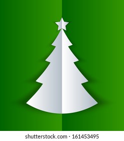 Simple Christmas tree made of folded paper with shadow on green background