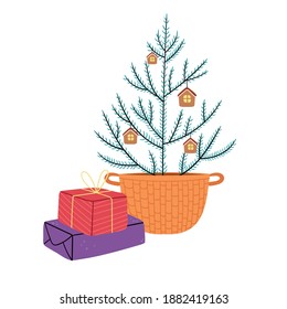 A simple Christmas tree in the Scandinavian style in a wicker basket. Gifts under the Christmas tree. Home decor in the Christmas style.
