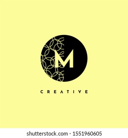 simple circle M logo letter with half patterned creative design concept isolated on yellow background