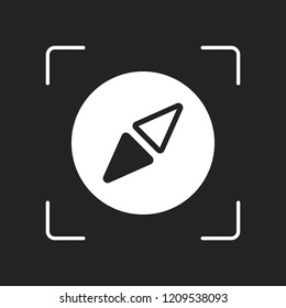 Simple compass icon. White object in camera autofocus on dark background