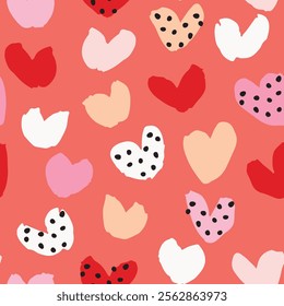 Simple cute hand painted brushy dotty hearts in a color palette of white, pink, beige, black and red on coral background. A seamless vector pattern. Great for home decor, fabric, wallpaper, gift wrap.