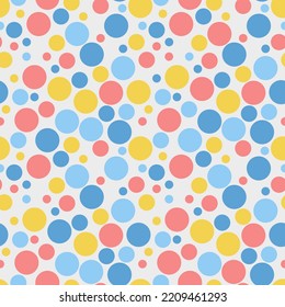 Simple cute motley geometric seamless pattern. Multi-colored circles of different sizes are randomly located on a light background. Vector.
