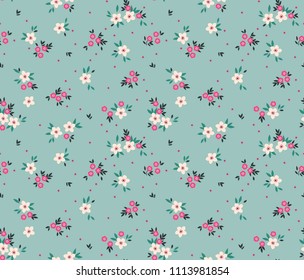 Simple cute pattern in small white and pink flowers on light blue background. Liberty style. Ditsy print. Floral seamless background. The elegant the template for fashion prints.