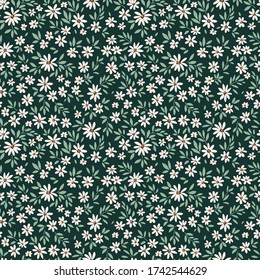 Simple cute pattern in small white  flowers on dark green background. Liberty style. Ditsy print. Floral seamless background. The elegant the template for fashion prints.