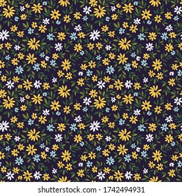 Simple cute pattern in small yellow and blue flowers on dark blue background. Liberty style. Ditsy print. Floral seamless background. The elegant the template for fashion prints.
