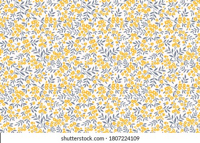 Simple cute pattern in small yellow flowers on white background. Liberty style. Ditsy print. Floral seamless background. The elegant the template for fashion prints.