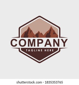 simple design badge with a geometric hexagon shape with a high mountain