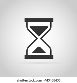 Simple flat icon of hourglass. Gray silhouette.