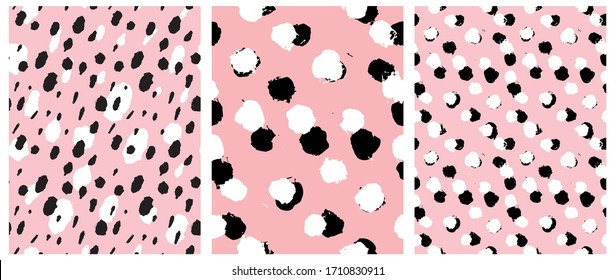 Simple Freehand Spots Seamless Vector Patterns. White and Black Hand Drawn Brush Dots Isolated on a  Light Pink Background. Rough Irregular Geometric Repeatable Print ideal for Fabric, Textile. 