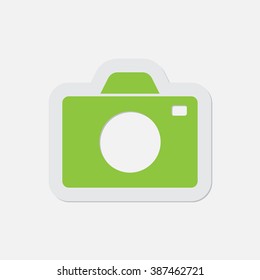 simple green icon with contour and shadow - camera on a white background