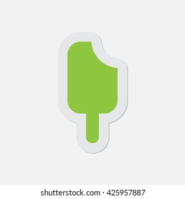 simple green icon with contour and shadow - stick ice cream on a white background