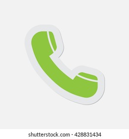 simple green icon with contour and shadow - telephone handset on a white background