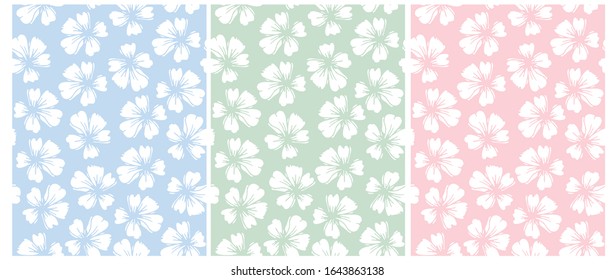 Simple Hand Drawn Floral Vector Patterns. Pastel Color Floral Repeatable Design.White Delicate Flowers Isolated on a Blue, Pink and Green Background. Garden Print for Fabric, Textile, Wrapping Paper.