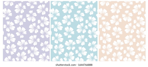 Simple Hand Drawn Floral Vector Patterns. Pastel Color Floral Repeatable Design.White Delicate Flowers Isolated on a Blue,Violet and Yellow Background.Garden Print for Fabric, Textile, Wrapping Paper.