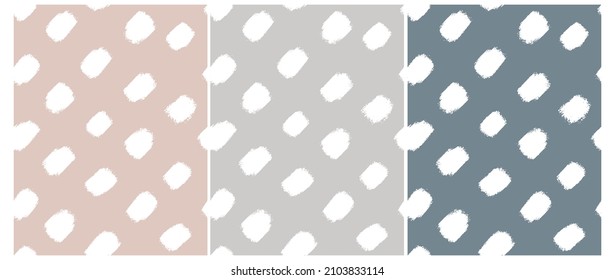 Simple Hand Drawn Irregular Dotted Vector Patterns. White Brush Dots Isolated on a Beige, Gray and Pale Blue Background. Infantile Style Abstract Geometric Print with Spots Ideal for Fabric, Textile.