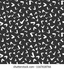 Simple hand-drawn ink doodles, seamless pattern, abstract geometric background. Random brush strokes. Simple and useful ink texture design. White spots on dark black background. Vector illustration.