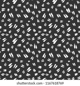 Simple hand-drawn ink doodles, seamless pattern, abstract geometric background. Random brush strokes. Simple and useful ink texture design. White spots on dark black background. Vector illustration.