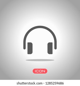 Simple headphones icon. Icon under spotlight. Gray background