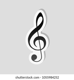 Simple icon of treble key. Sticker style with white border and simple shadow on gray background