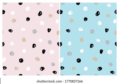 Simple Irregular Freehand Doodle Vector Patterns. Black, White and Gold Hand Drawn Spots on a  Light Blue and Pastel Pink Background. Infantile Style Abstract Dotted Vector Print. Geometric Backdrop.