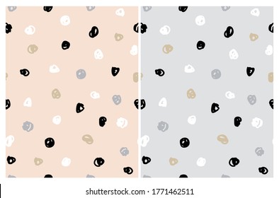 Simple Irregular Freehand Doodle Vector Patterns. Black, White and Gold Hand Drawn Spots on a  Light Gray and Light Salmon Pink Background. Infantile Style Abstract Dotted Vector Print. Geometric Back