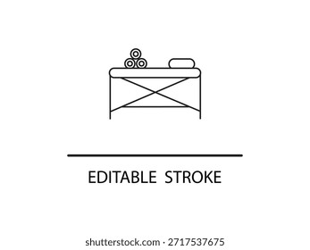 Simples ícone de linha de uma mesa de massagem com toalhas.