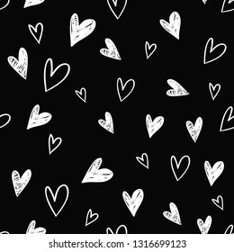Simple little hearts. Hand drawn white line sketch seamless pattern on black background. Doodle brush, pen, marker illustration. Scribble ornament backdrop.
