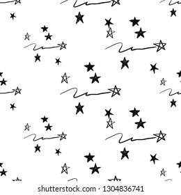 Simple little stars. Hand drawn black line seamless pattern on white background. Doodle brush, pen, marker illustration. Scribble ornament background.