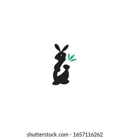 Simple logo design for a rabbit holding a carrot for rabbit conservation